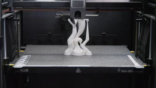 A 3D printer in the process of printing a complex, white organic sculpture, showcasing how stable temperatures are crucial for detailed PLA prints with overhangs.